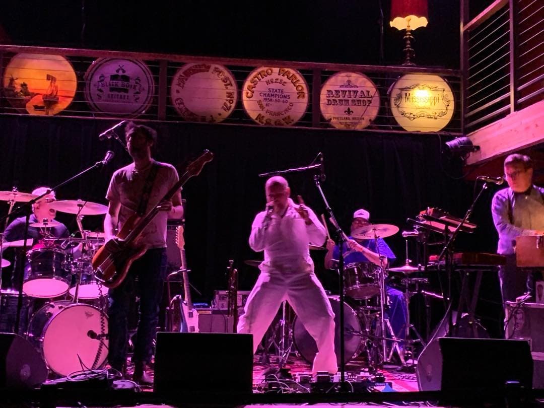 a band performs on stage in front of a crowd
